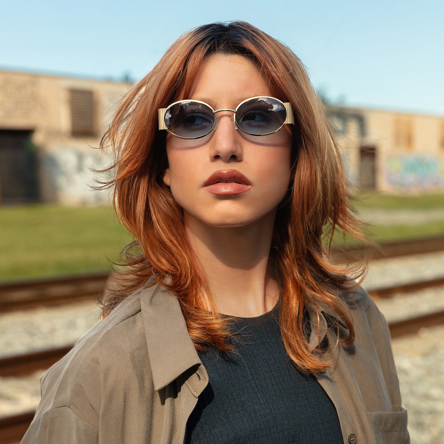 Model wearing Belle Meade Sunglasses in Gold Havana with Blue Gradient outdoors looking to her right