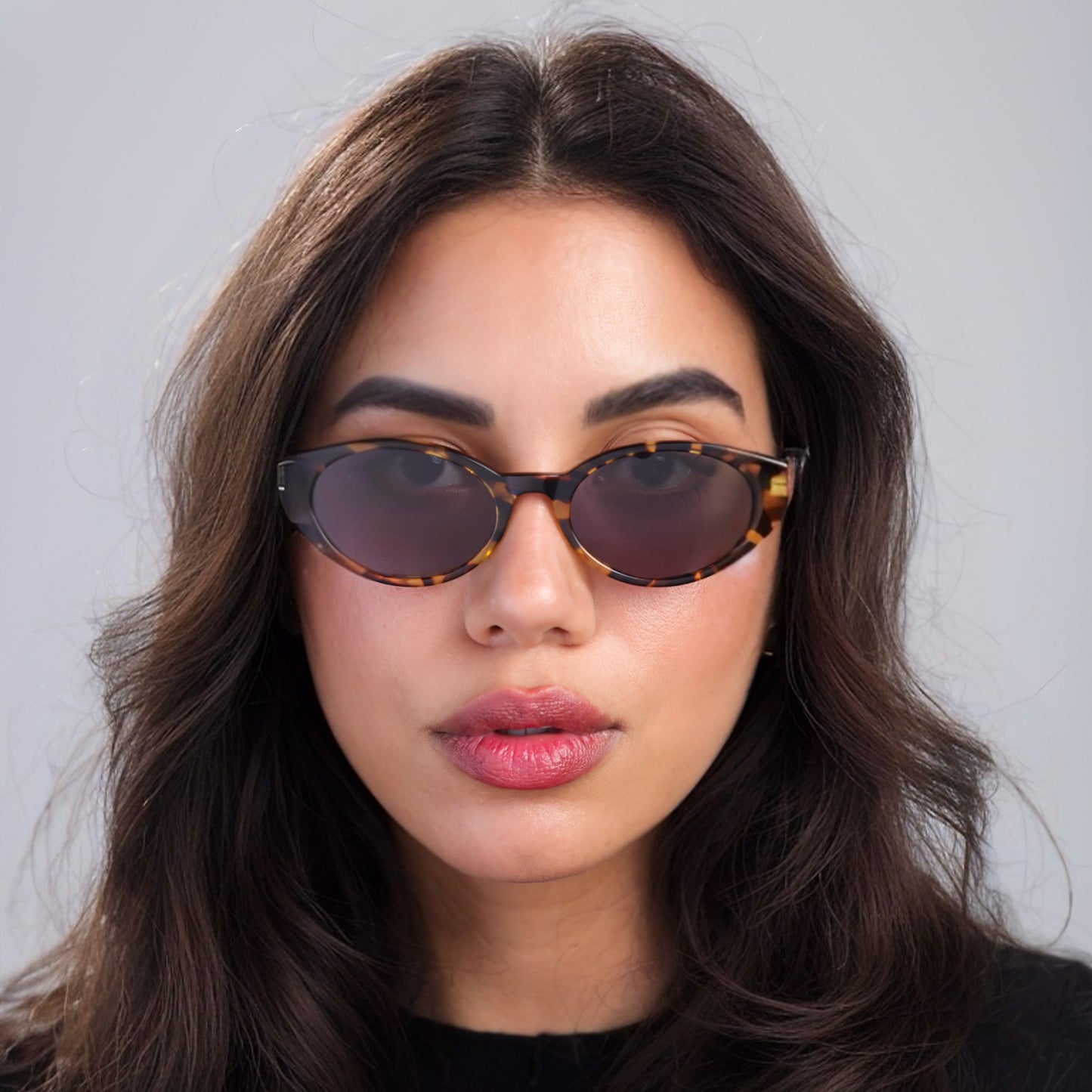 Brunette woman wearing Collins Sunglasses in Golden Oak with Grey lenses