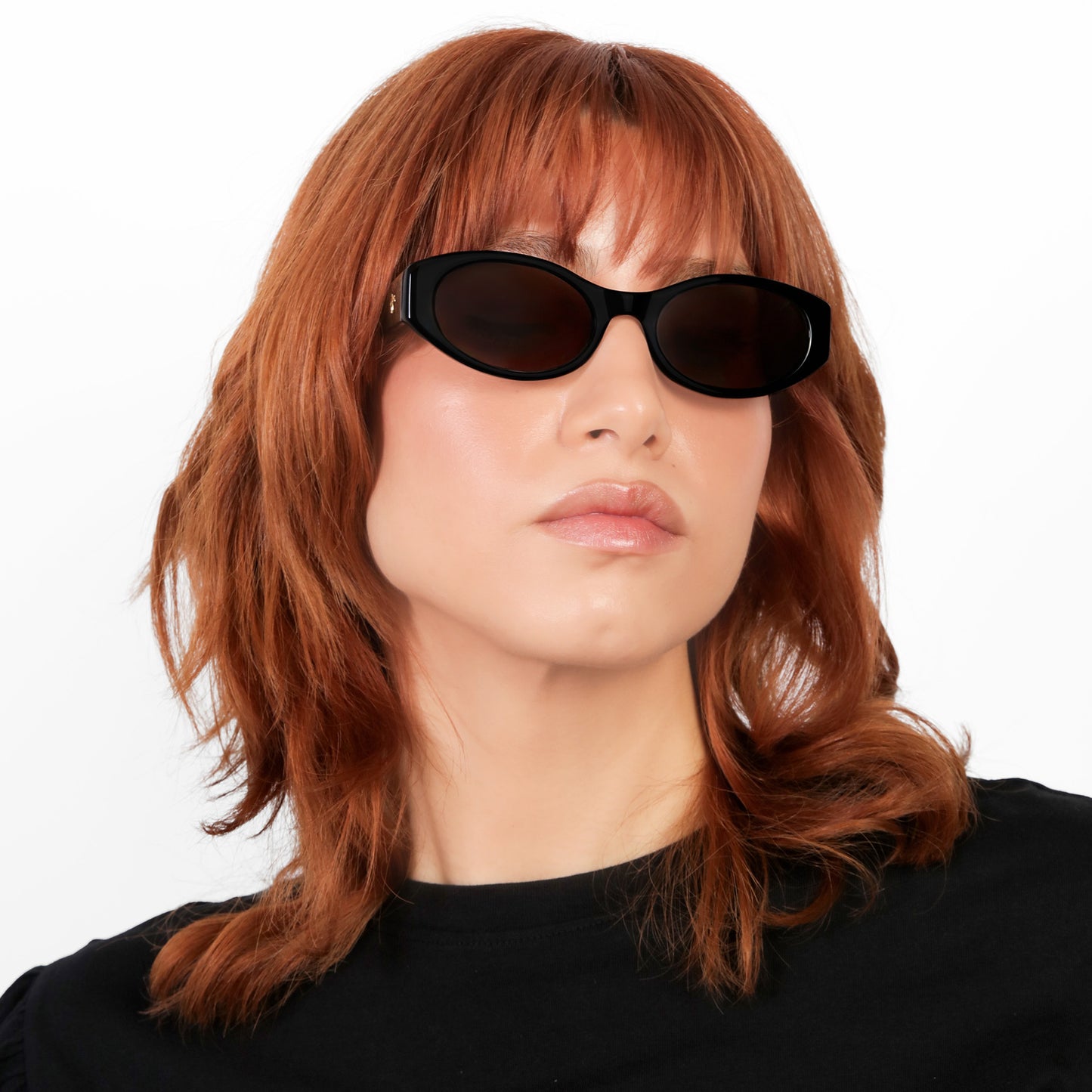 Another angle of model wearing Exumas Sunglasses in Black with Brown lenses