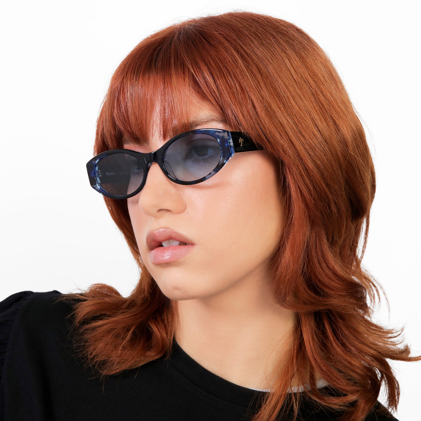 Another angle of model wearing Exumas Sunglasses in Lapis with Blue Gradient lenses