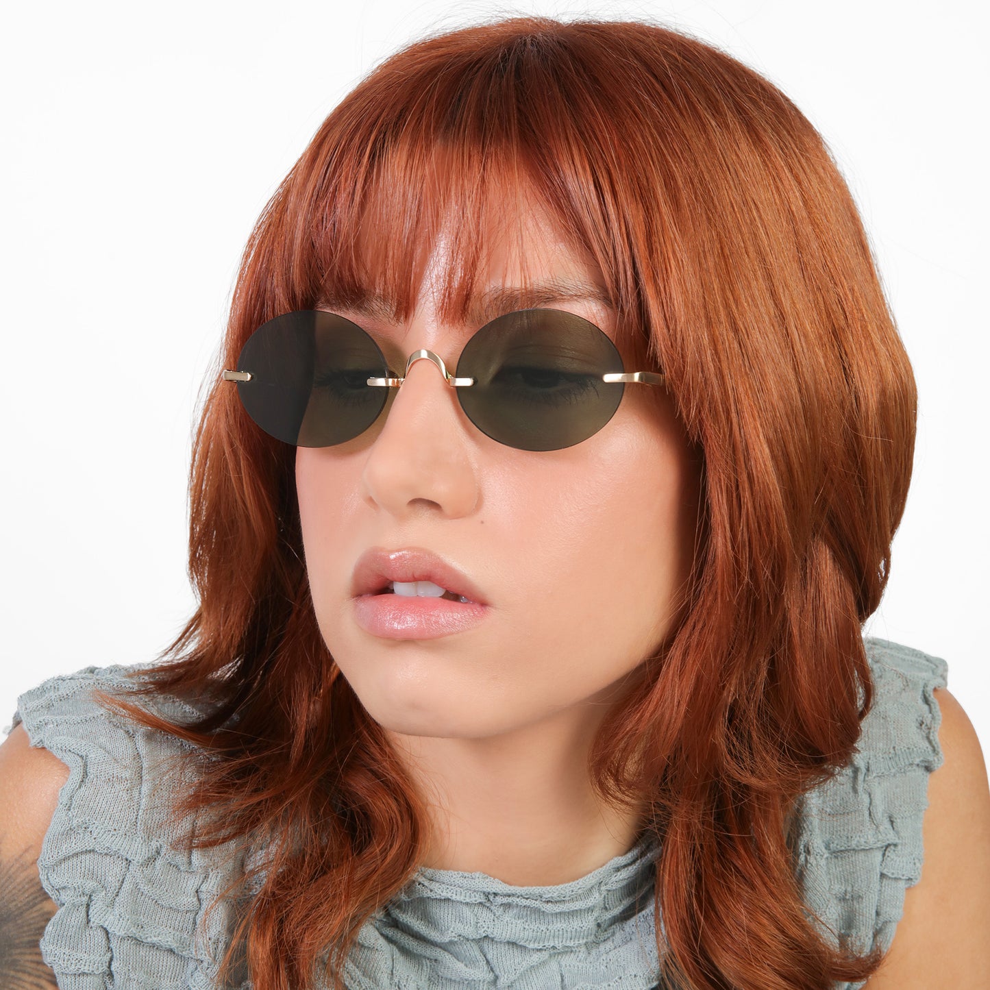 Another angle of model wearing Havana Sunglasses in Gold with Olive lenses