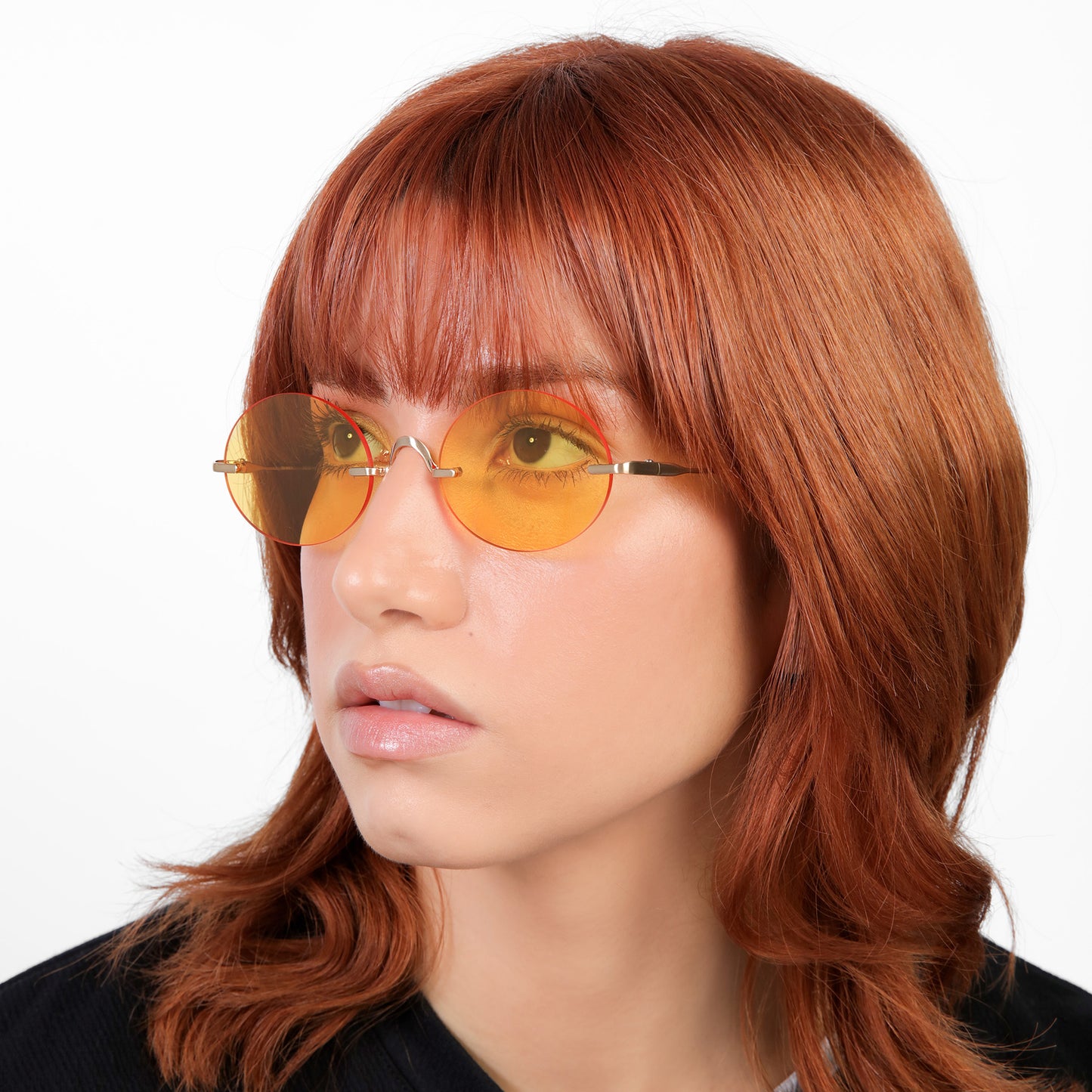 Model wearing Havana Sunglasses in Gold with Orange See Through lenses