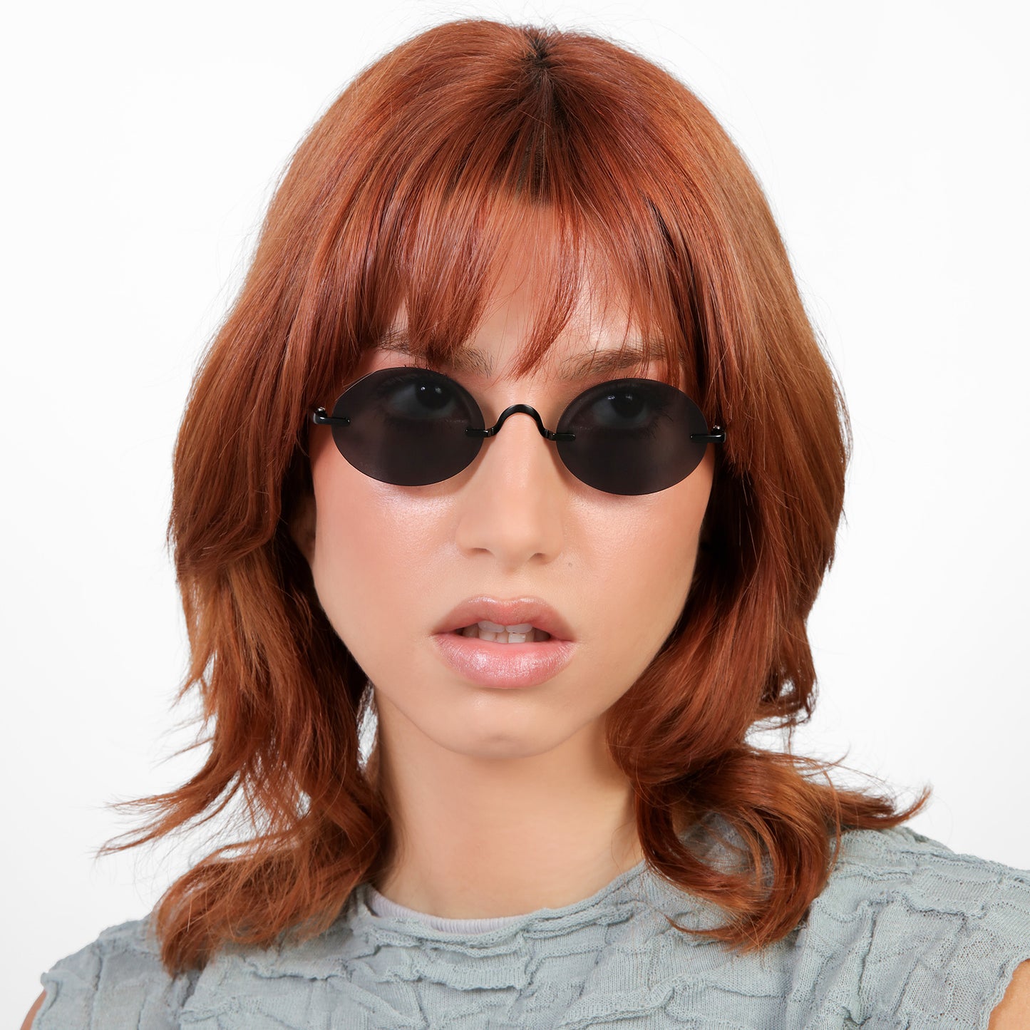 Another angle of model wearing Havana Sunglasses in Matte Black with Grey lenses