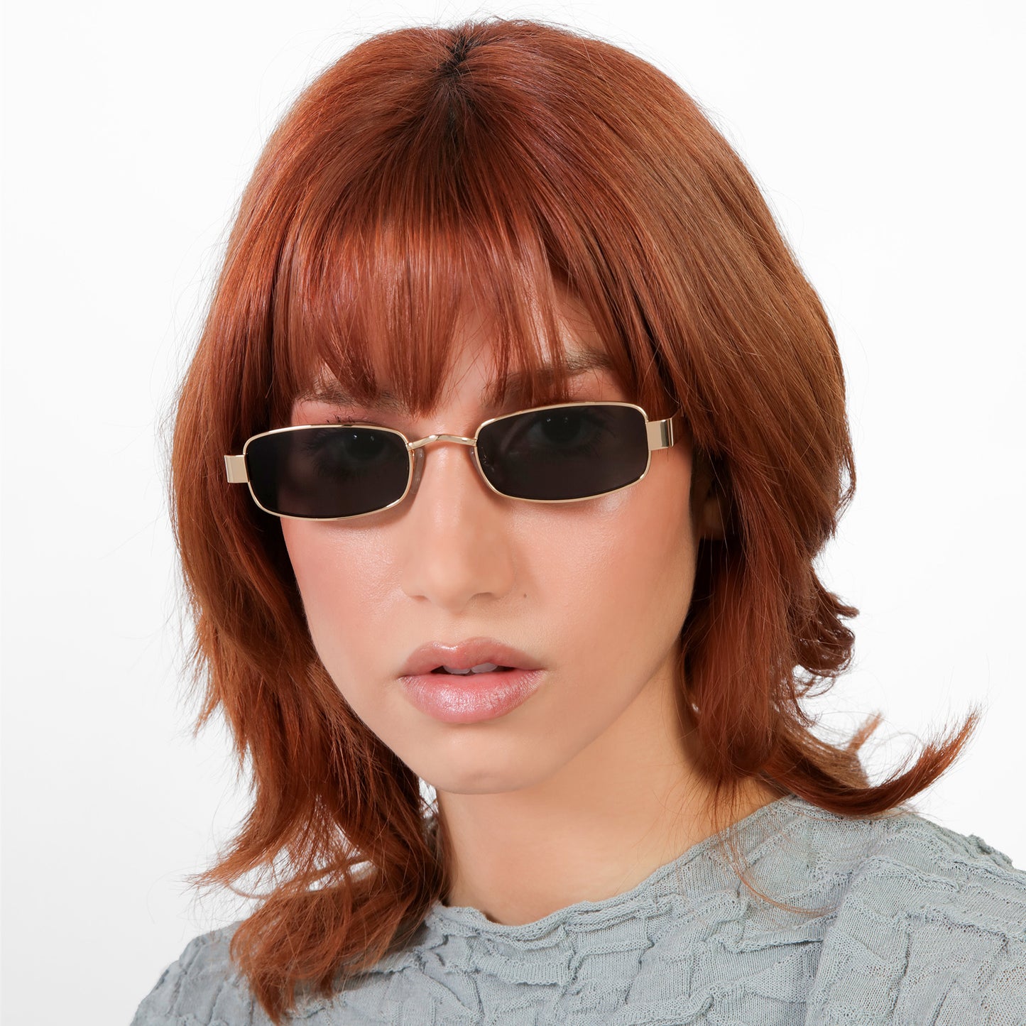 Model wearing Shores Sunglasses in Gold with Grey lenses