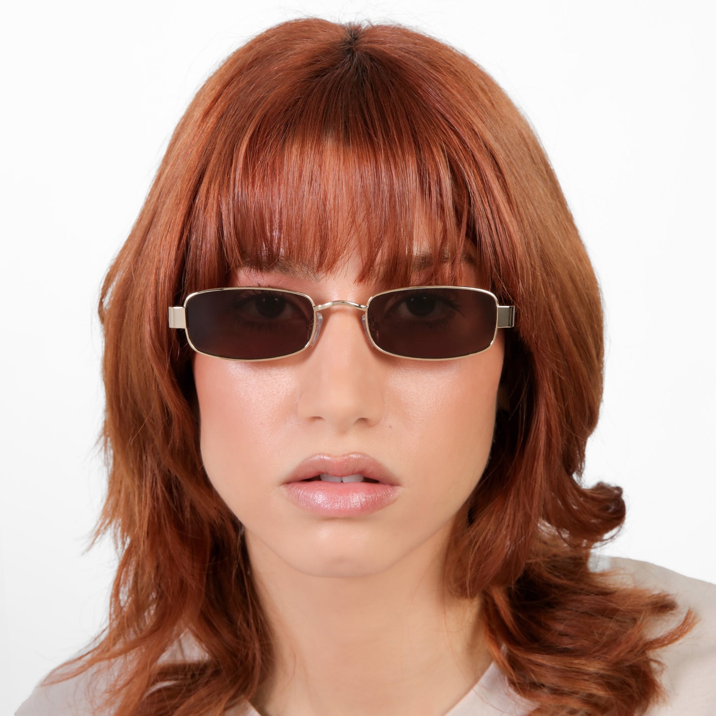 Model wearing Shores Sunglasses in Gold with Brown lenses