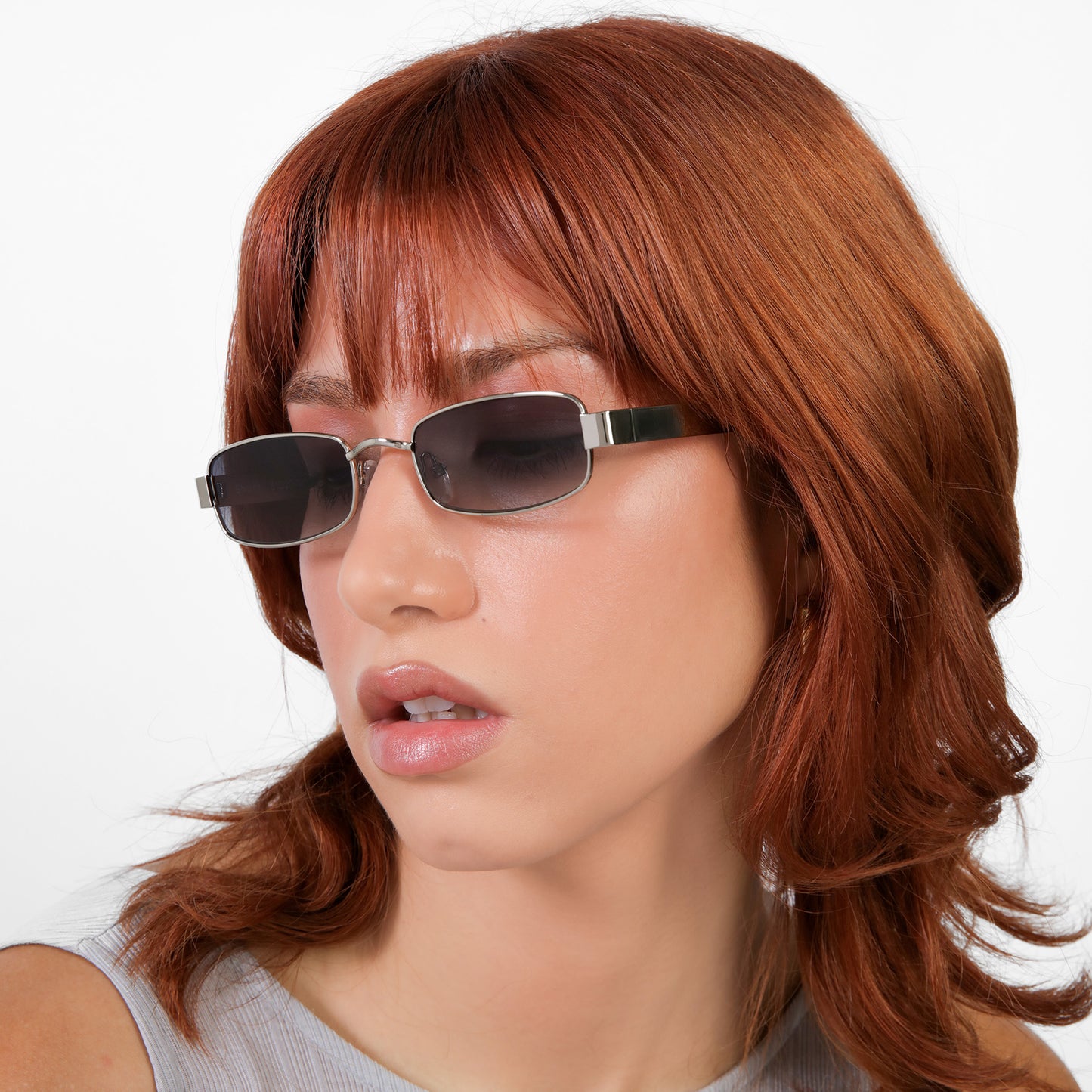 Close-up of model wearing Shores Sunglasses in Silver with Grey Gradient lenses