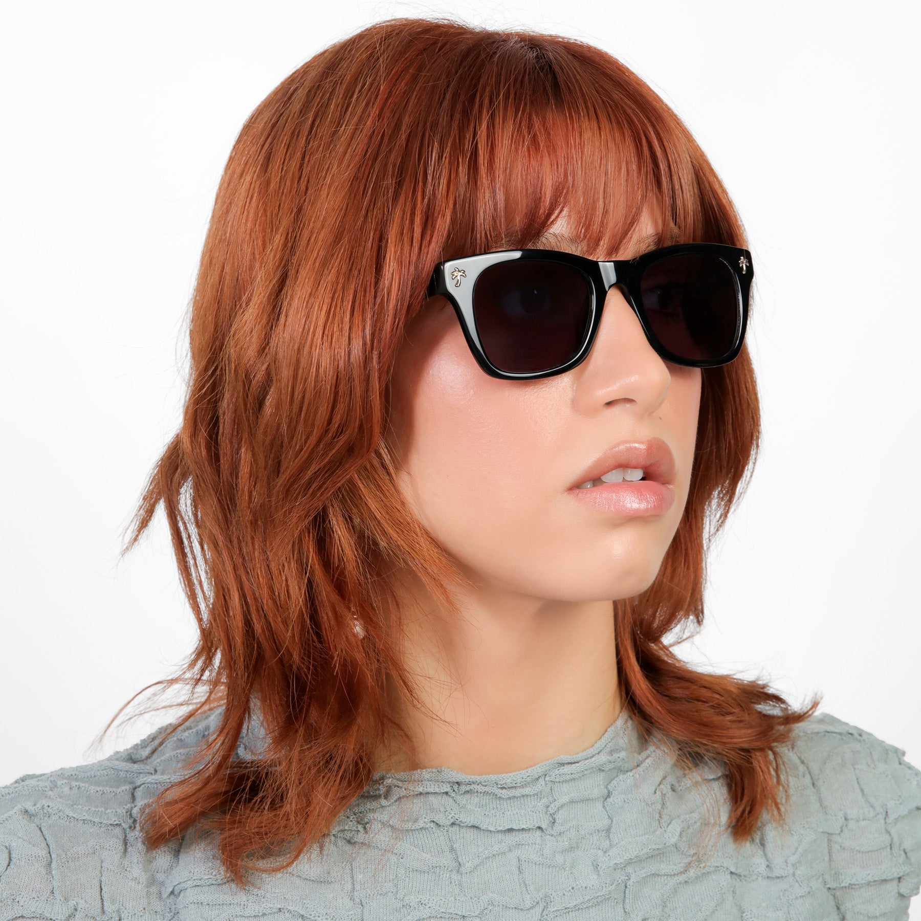 Another angle of model wearing Hibiscus Sunglasses in Black with Grey lenses