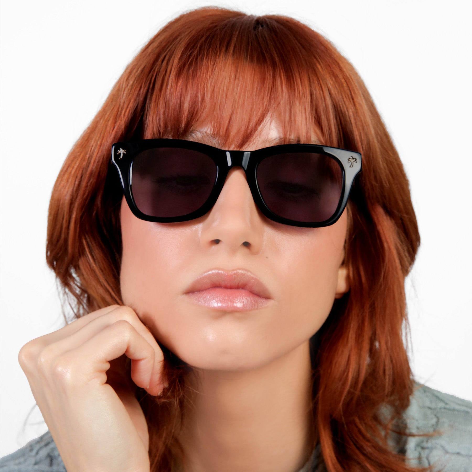 Close up of model featured wearing Hibiscus Sunglasses in Black