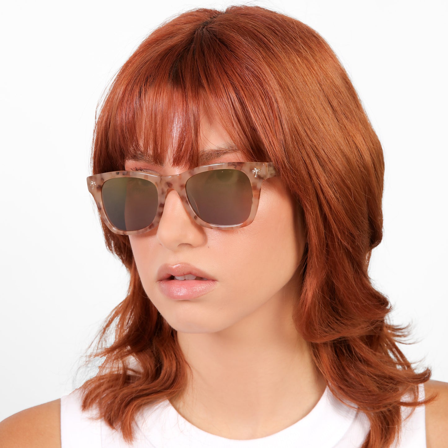 Another angle of model wearing Hibiscus Sunglasses in Pink Marble with Copper Mirror lenses