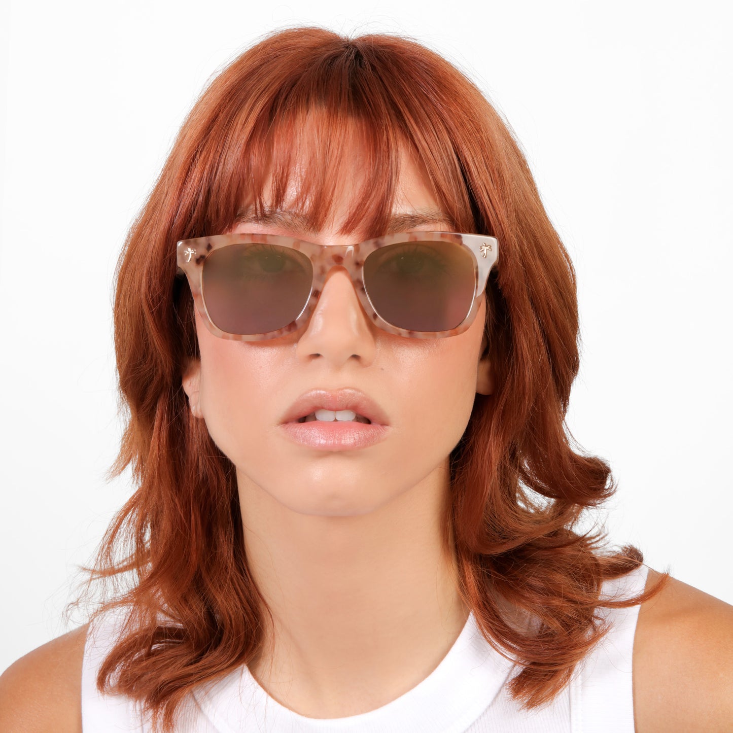Model wearing Hibiscus Sunglasses in Pink Marble with Copper Mirror lenses