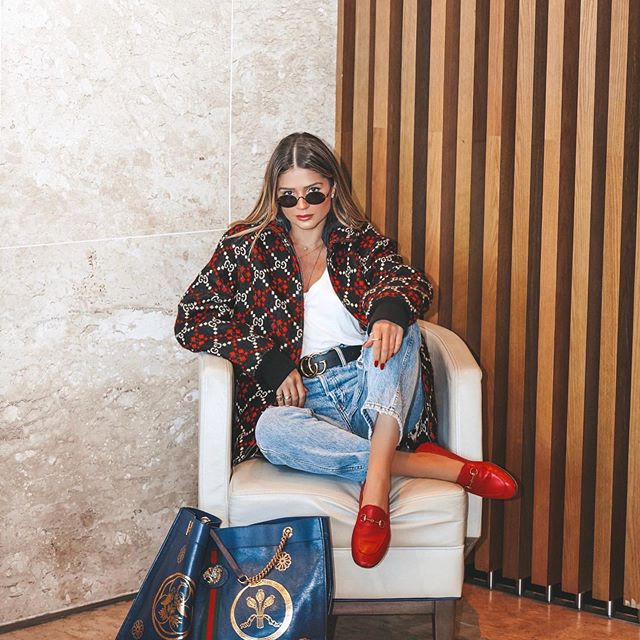 Model wearing the Grove II Sunglasses in a hotel lobby