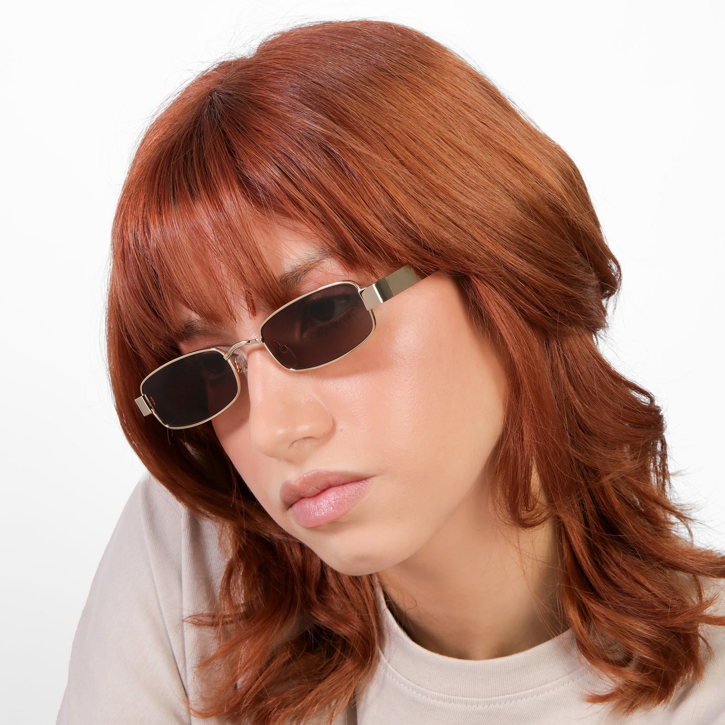 Another angle of model wearing Shores Sunglasses in Gold with Brown lenses