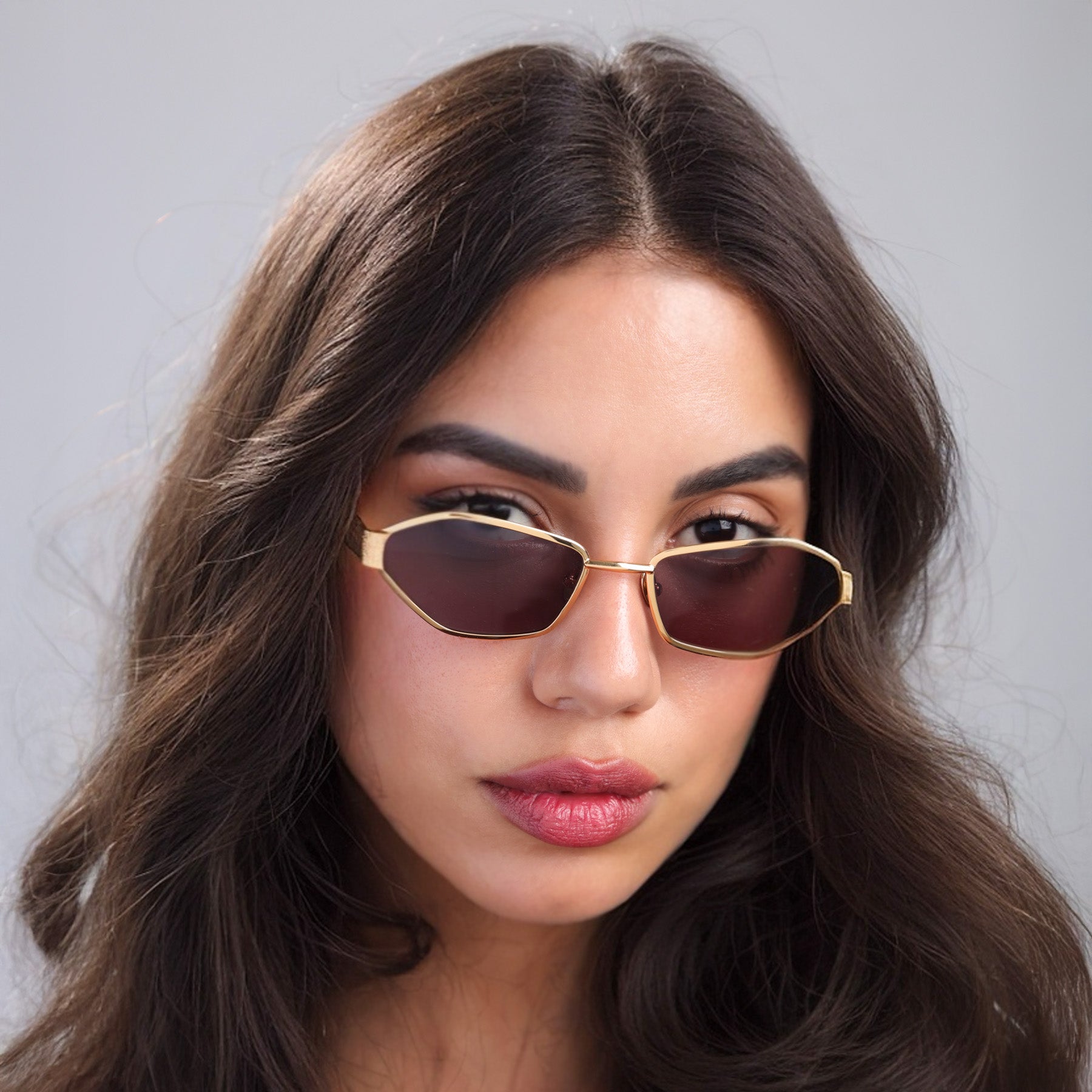 Brunette woman wearing Vista Sunglasses in Gold with Brown lenses